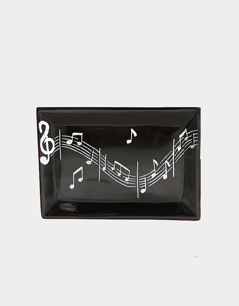 In celebration of universal language of music, Kenyan artisan Adorn hand carved soapstone tray with a black exterior and hand etched musical stuffs and notes.