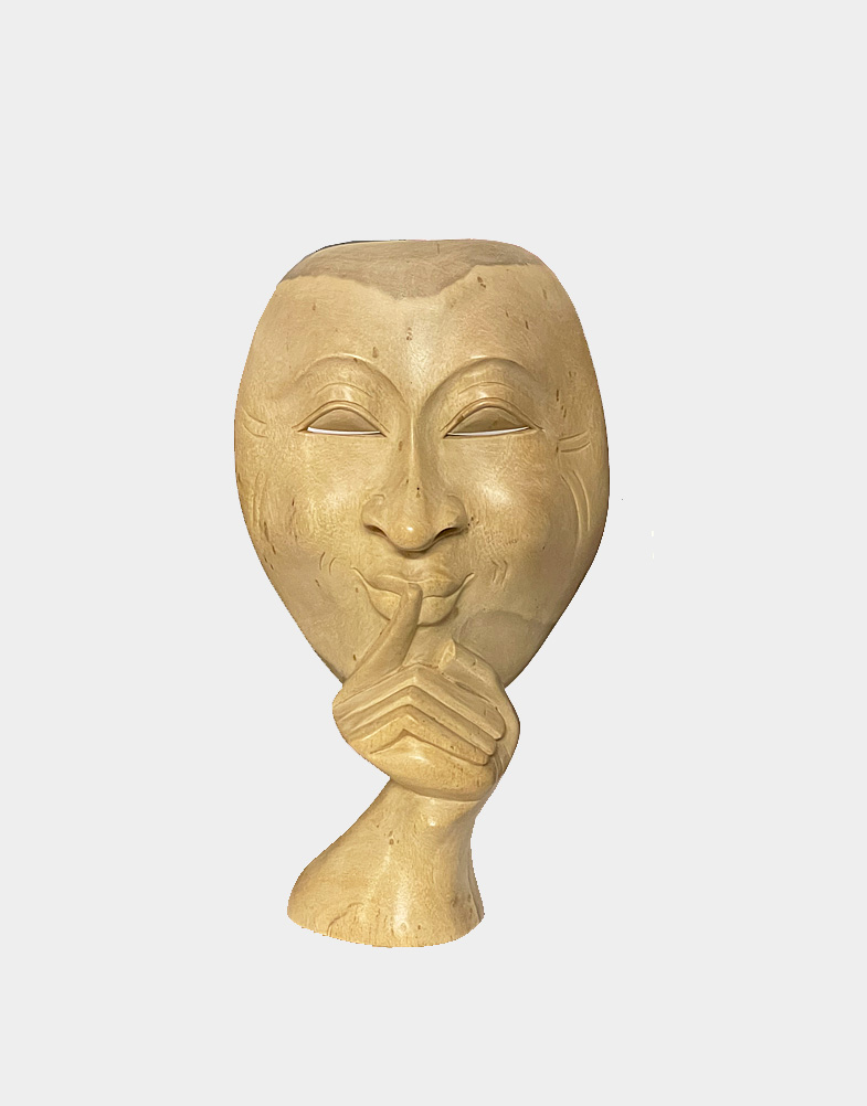 A secretive expression courses through the smooth details of this mask. One finger appears raised to his lips, asking for a silence. A hand-carved masterpiece.