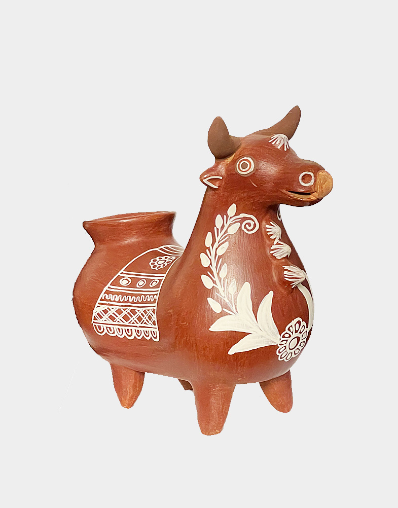A cheerful bull with a kindly face is dressed for a festive celebration. Crafted of terracotta and painted by hand. Not watertight, for decorative use only.