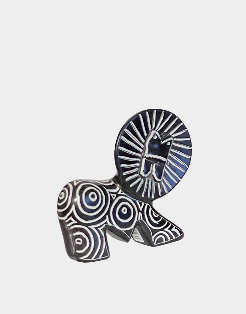 The Kilimanjaro Lion represents international commerce and sustainability. This soapstone lion is carved by Gusii tribe in western Kenya with a "kisu" knife.