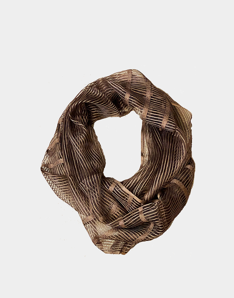 This super light weight bronze infinity scarf is a fine sheer weave of silk and viscose yarn. This beautiful fair trade scarf has an elegant, classic design.
