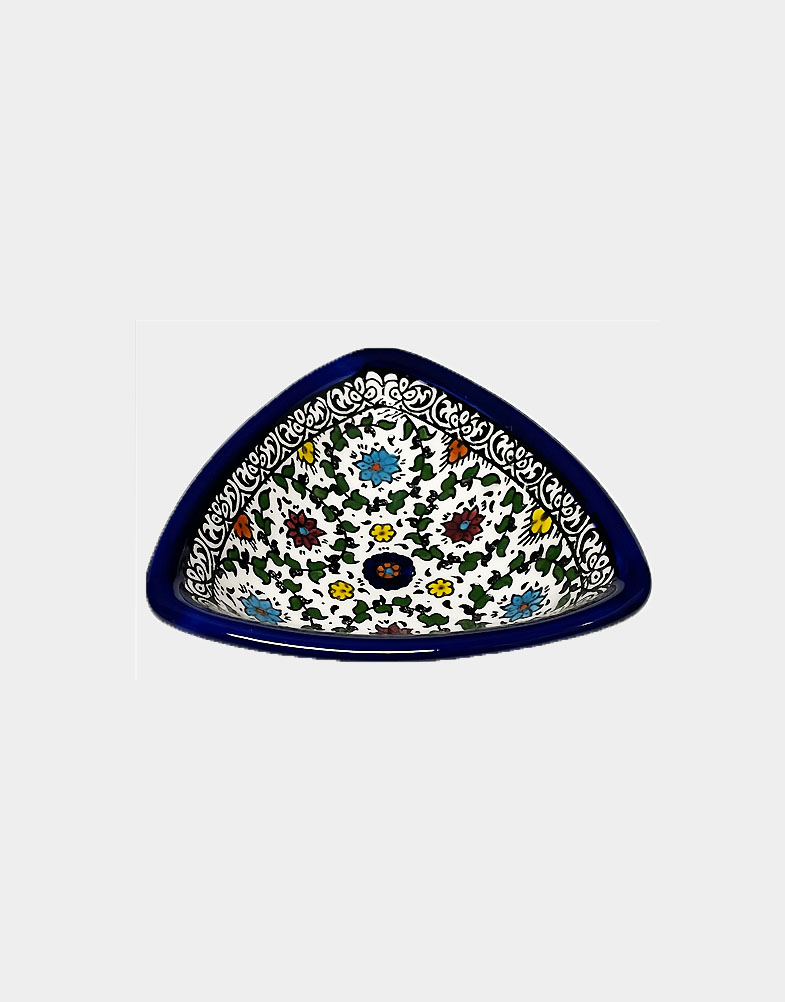 Colorful triangle-shaped dishes are intricately hand painted in bold floral designs, a traditional Palestinian craft. Microwave safe. Hand wash recommended.