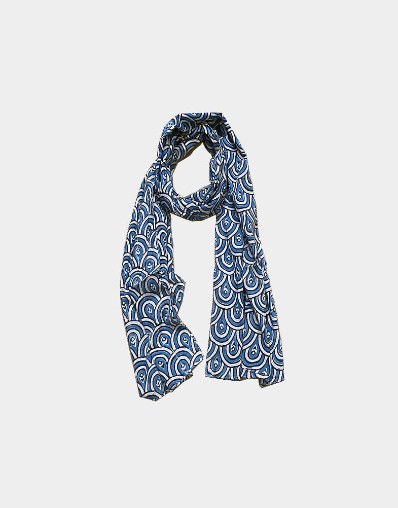 A light-weight ethical cotton scarf that features a blue and white block print like peacock feather. This scarf is 100% cotton and hand block printed in India.